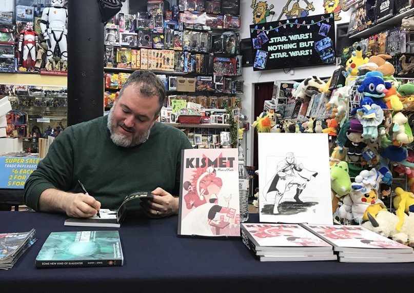Author A. David Lewis signs his new graphic novel, “Kismet, Man of Fate,” at Comicazi comic store north of Boston on Dec. 4, 2018. RNS photo by Aysha Khan